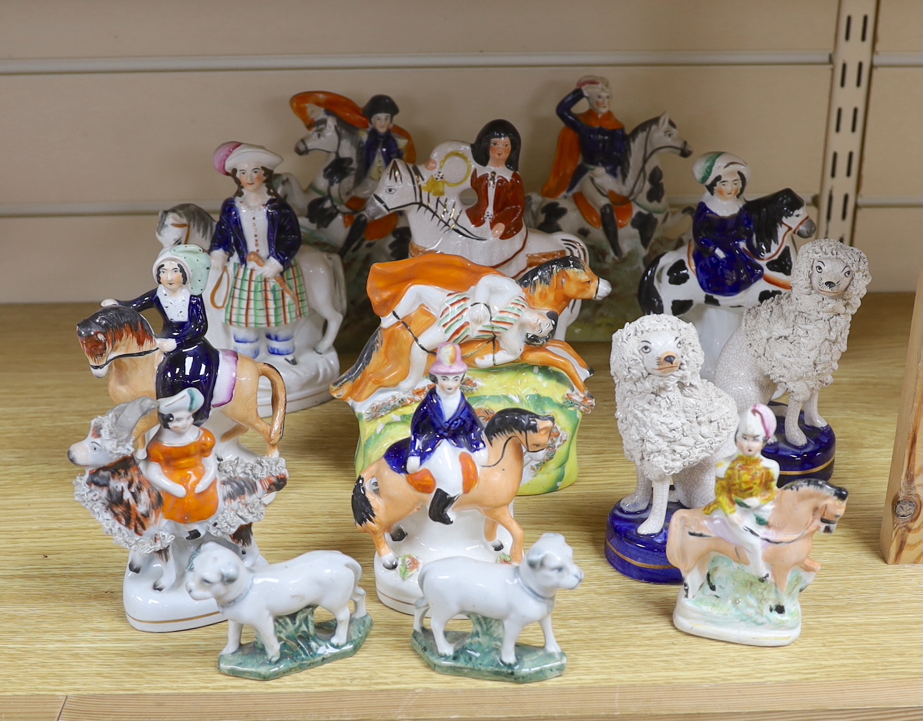 Nine Victorian Staffordshire figures or groups, three reproductions and a pair of Continental porcelain figures of dogs, tallest 17.5cm